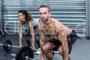 Muscular couple lifting weight together