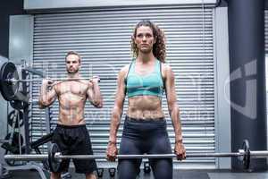 Muscular couple lifting weight together