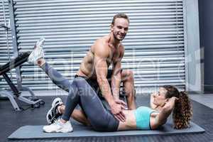 Muscular couple doing abdominal exercises