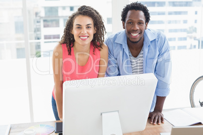 Two creative business colleagues looking at the camera