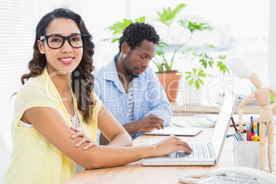 Pretty young businesswoman smiling at the camera