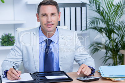 Professional businessman writing on his notebook