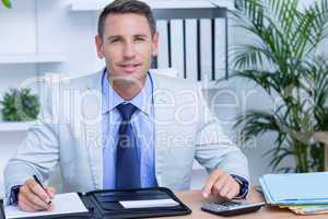 Professional businessman writing on his notebook