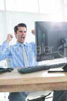 Cheerful businessman cheering in office