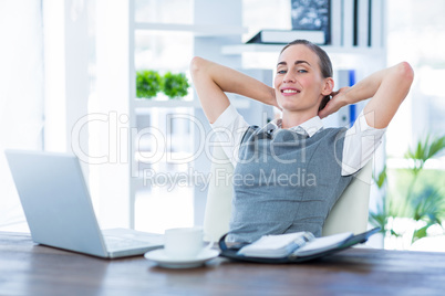 Businesswoman relaxing in a swivel chair