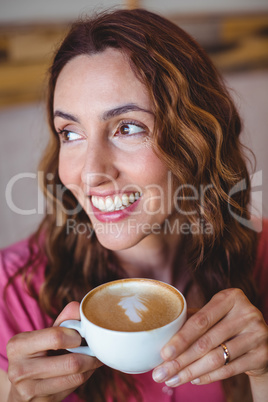 Pretty brunette having cup of coffee