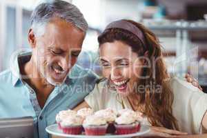 Cute couple looking at cakes