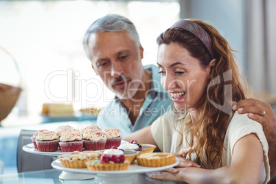 Cute couple looking at pastries