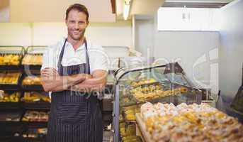 Portrait of a smiling baker with arm crossed