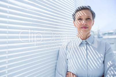 Smiling businesswoman standing in the office