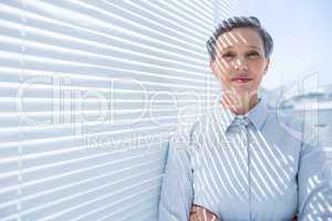 Smiling businesswoman standing in the office