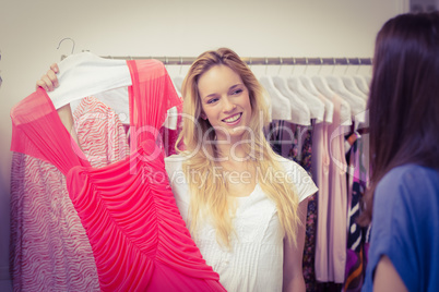 Happy blonde showing a red dress