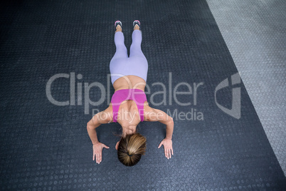 Muscular woman doing push ups