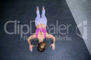 Muscular woman doing push ups