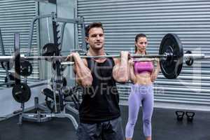 Muscular couple lifting weight together