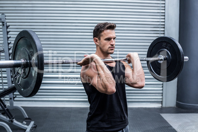 Muscular man holding a barbell