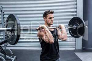 Muscular man holding a barbell