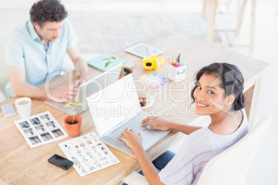 Casual business partners working on laptop