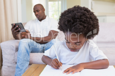 A little boy writing on notepad