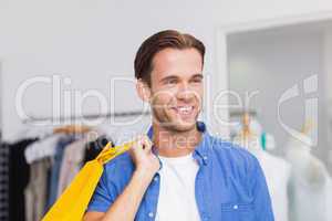 A smiling man with shopping bags