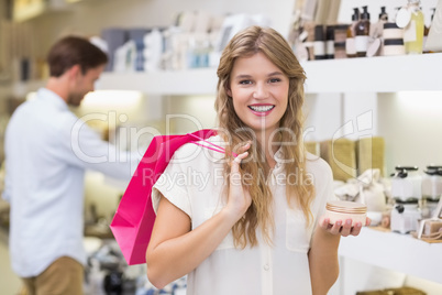 A pretty blonde woman looking at beauty product