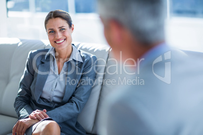 Business people speaking together on couch