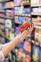 A pretty woman showing a jar