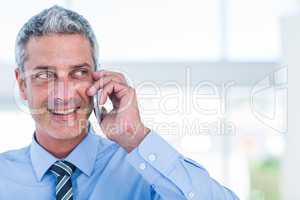 Happy businessman having a phone call