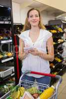 Woman writing in her notepad in aisle