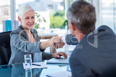 Happy business people shaking hands