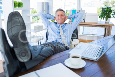 Businessman relaxing in a swivel chair