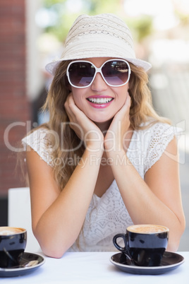 Pretty hipster woman at the cafe terrace