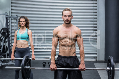 Muscular couple lifting weight together Muscular couple lifting weight together
