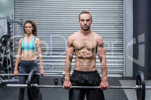 Muscular couple lifting weight together