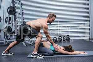 Muscular couple doing a body stretching