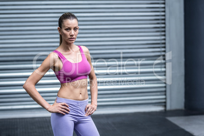 Serious muscular woman looking at camera