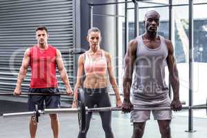 Three muscular athletes lifting barbells