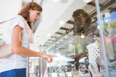 Surprised woman pointing the window