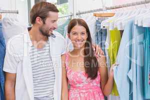 Smiling couple looking at clothes