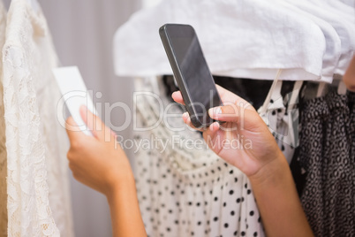 Woman taking a photo of price tag