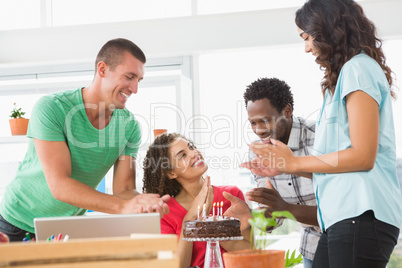 Smiling colleagues celebrating birthday