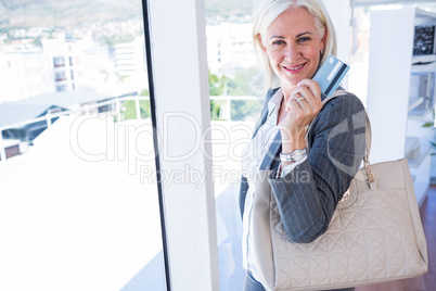 Happy businesswoman holding credit card