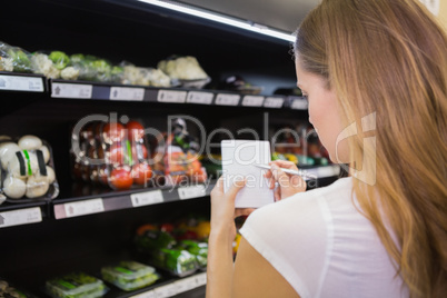 Woman writing in her notepad in aisle