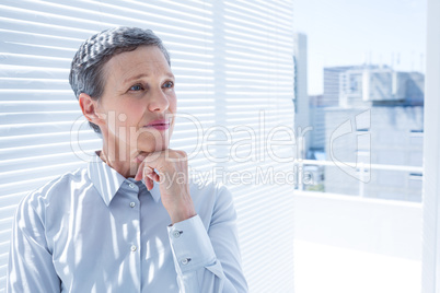 Businesswoman looking away with arms folded