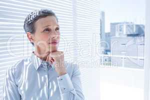 Businesswoman looking away with arms folded