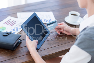 Businesswoman using tablet pc and holding credit card