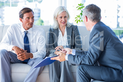 Business people speaking together on couch