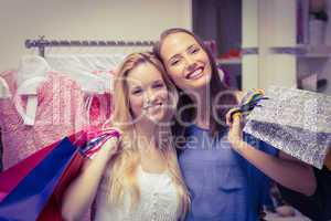 Happy friends holding shopping bags