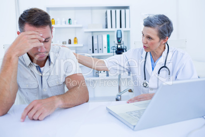 Doctor speaking to her sad patient