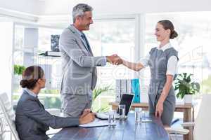 Business people shake hands during interview
